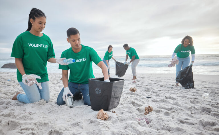 Collaboration, charity and recycling with people on beach for sustainability, environment and eco f.